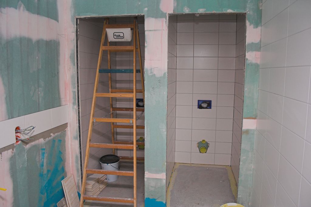 Das Bild zeigt Fliesenarbeiten in den sanitären Anlagen neben dem Schulungsraum.